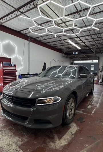Dodge Charger with ceramic window tint under shop lights in Houston, TX