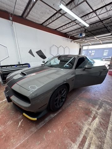Gray Dodge Challenger with dark window tint in Houston, TX