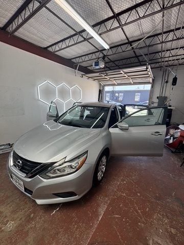 Silver Nissan Altima with window tint in Houston, TX