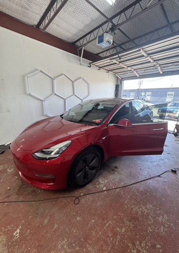 Red Tesla Model 3 with ceramic window tint in Houston, TX